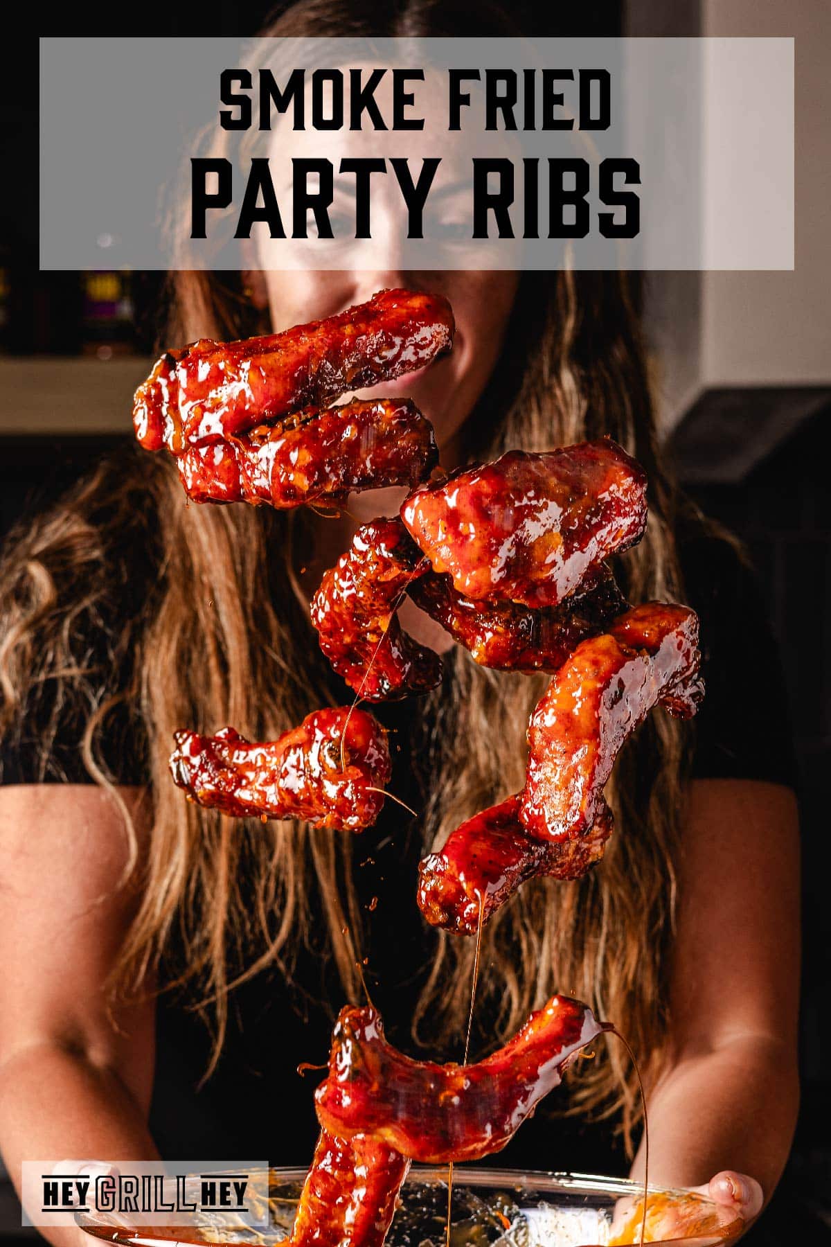 Sauced ribs being tossed in the air in front of cook. Text reads "Smoke Fried Party Ribs."