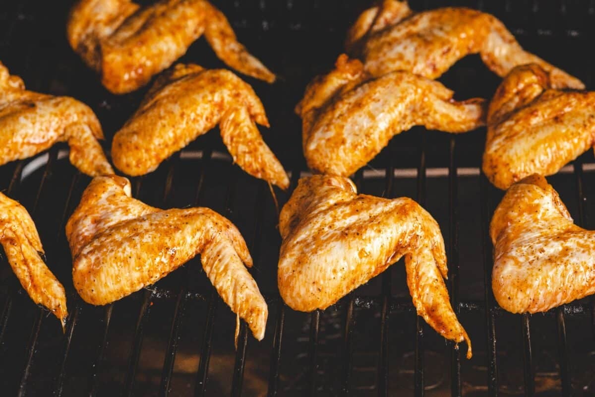 Chicken wings cooking on the smoker.