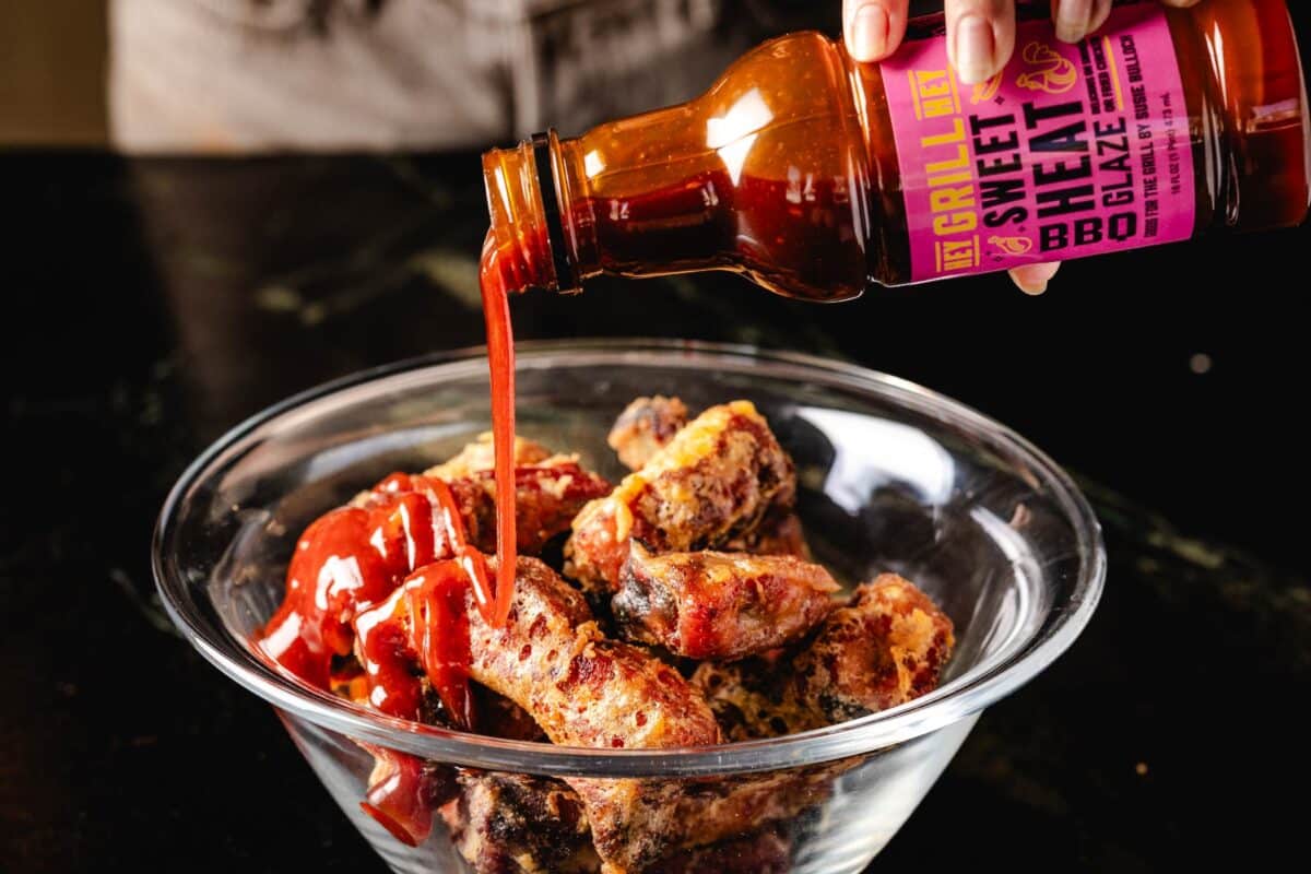 Ribs in bowl being glazed with Wing Night Kit ingredients.