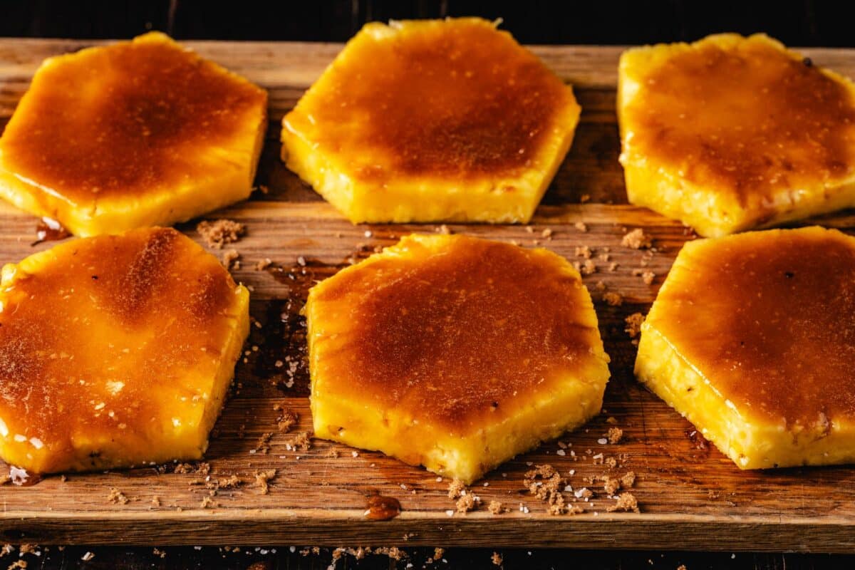 Fruit slices on a cutting board seasoned with brown sugar.