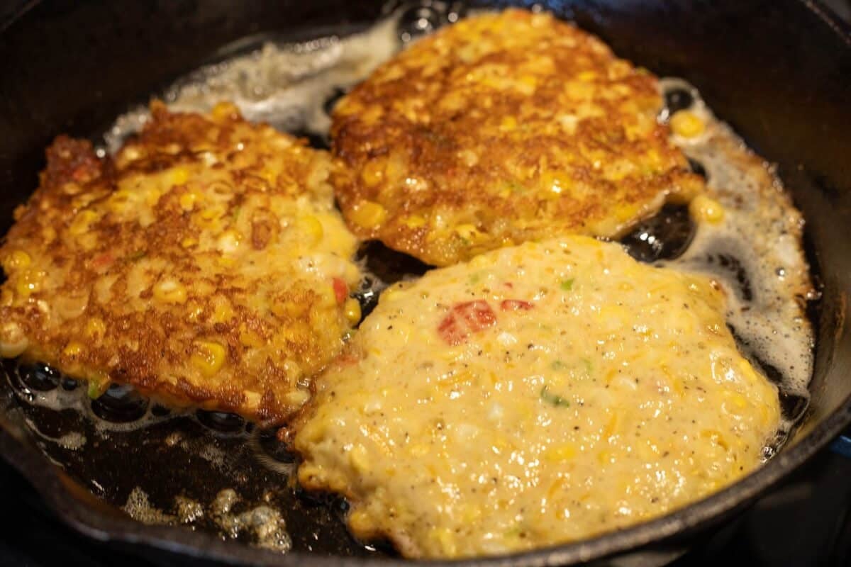 Cast iron skillet with oil frying batter.