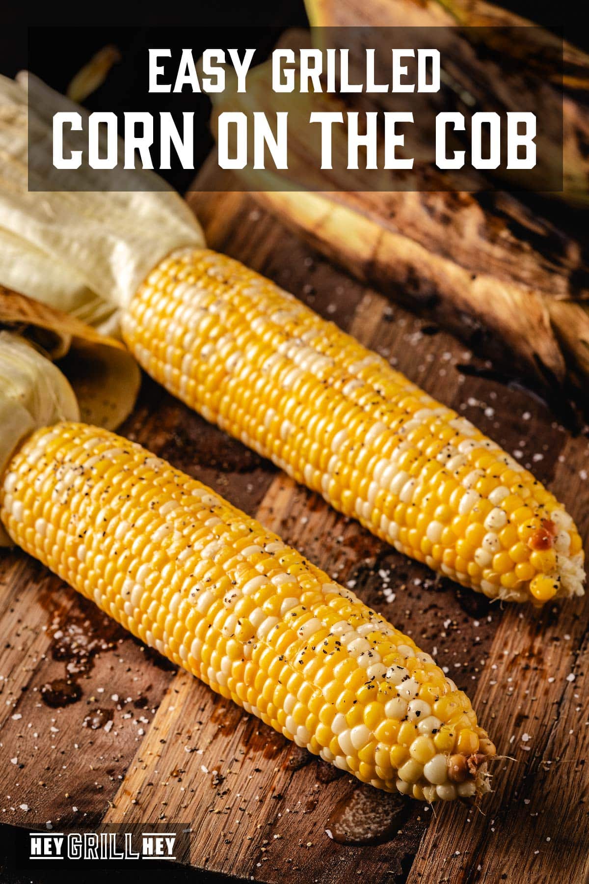 Grilled corn cobs on a wooden serving platter. Text overlay reads "Easy Grilled Corn on the Cob."