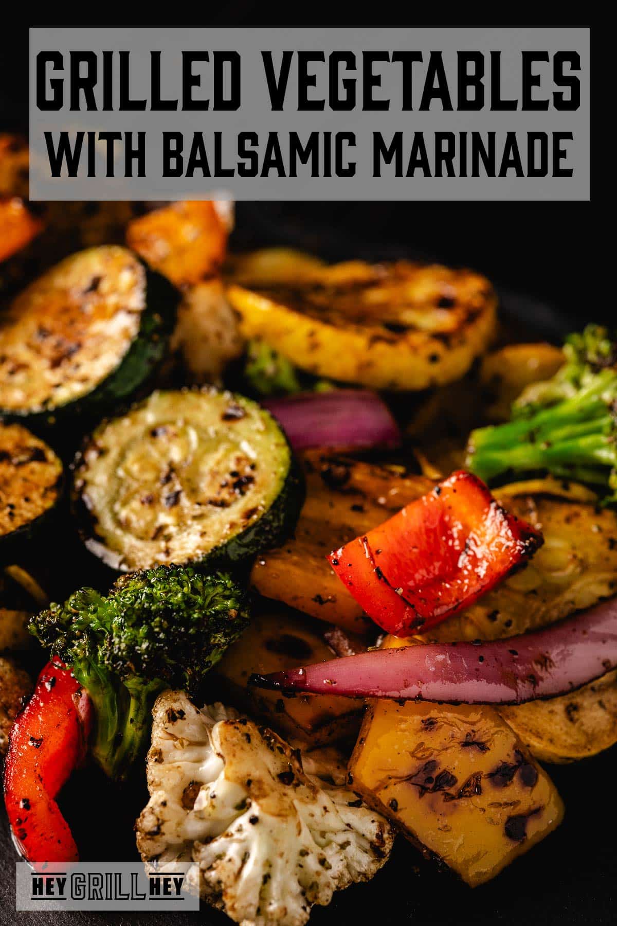 Various grilled vegetables with charring. The text overlay and the top reads "Grilled Vegetables with Balsamic Marinade," and the small one at the bottom reads "Hey Grill Hey."