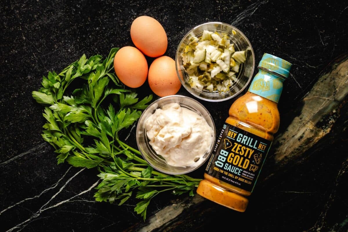 Zesty Gold Sauce, cilantro, mayo, and other raw ingredients gathered on a countertop.