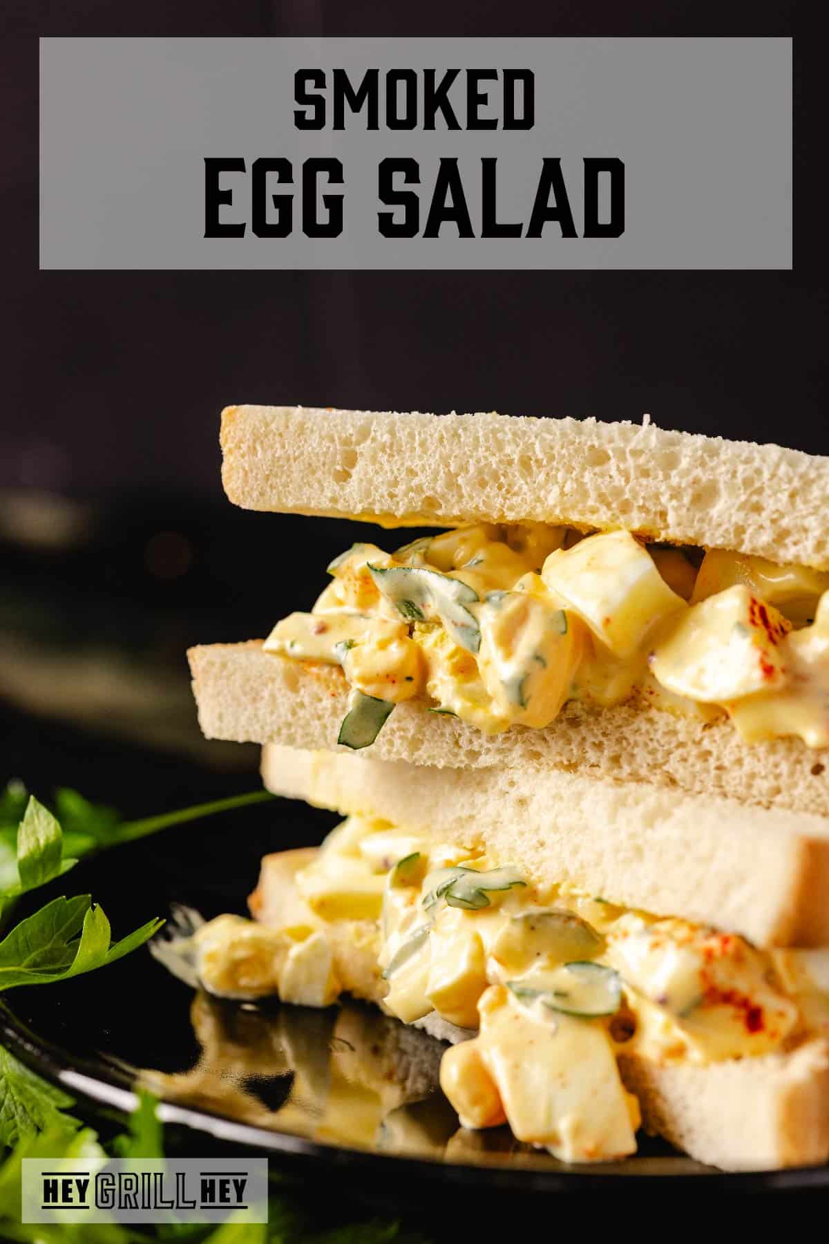 An egg salad sandwich with fresh garnish. The text overlay reads "Smoked Egg Salad."