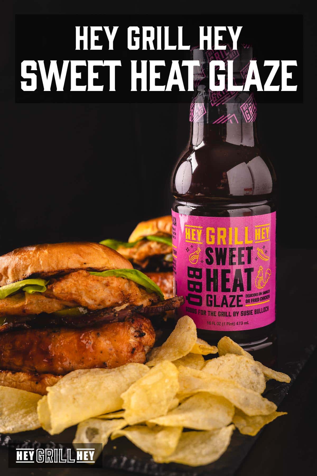 A bottle of sauce next to a chicken sandwich with lettuce, and a pile of potato chips. Text overlay reads "Hey Grill Hey Sweet Heat Glaze."