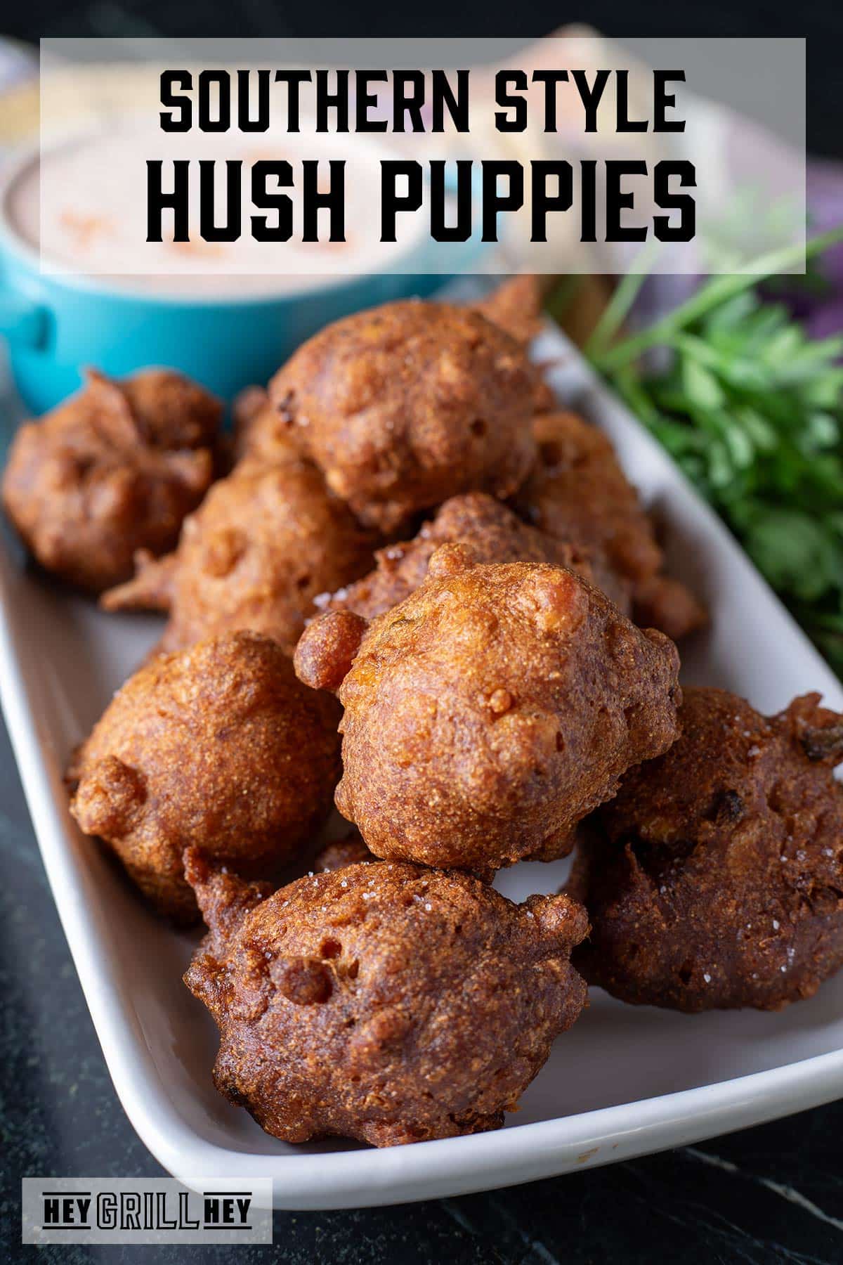 Hush puppies and a blue cup with sauce on a white plate. The text overlay reads "Southern Style Hush Puppies."