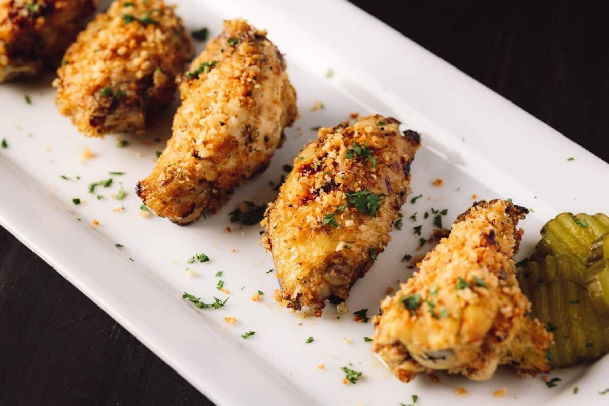 Dill pickle chicken wings on a white plate.