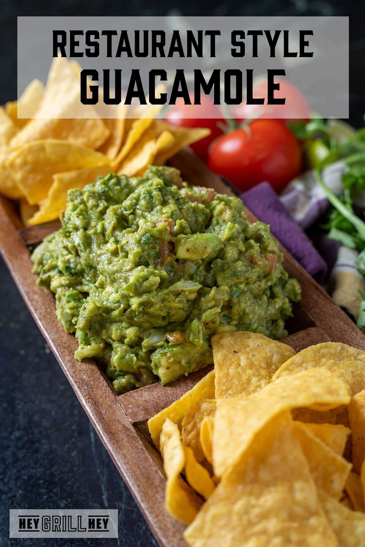 Fresh guacamole in a wooden serving tray with tortilla chips. The text overlay reads "Restaurant Style Guacamole."