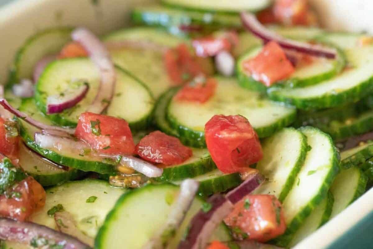 Sliced cucumbers and tomatoes drizzled with dressing.