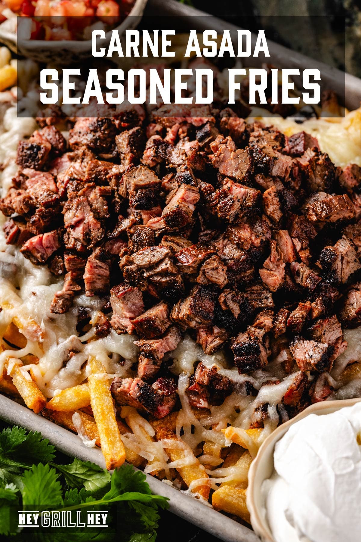 A baking sheet with loaded fries. The text overlay reads "Carne Asada Seasoned Fries" at the top, and "Hey Grill Hey" at the bottom.