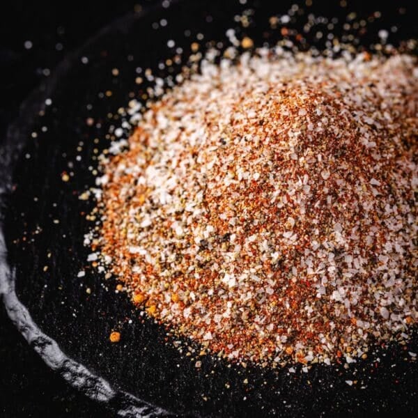 A pile of burger seasoning on a plate stone platter.