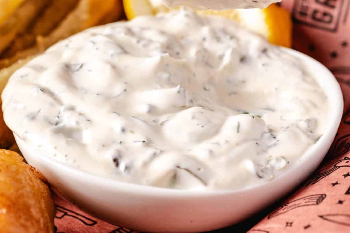 A white bowl of tartar sauce.