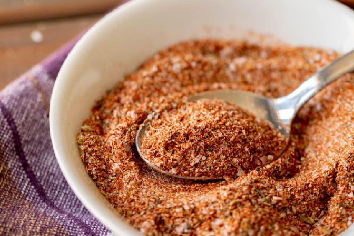 A white bowl filled with a seasoning recipe for seafood.