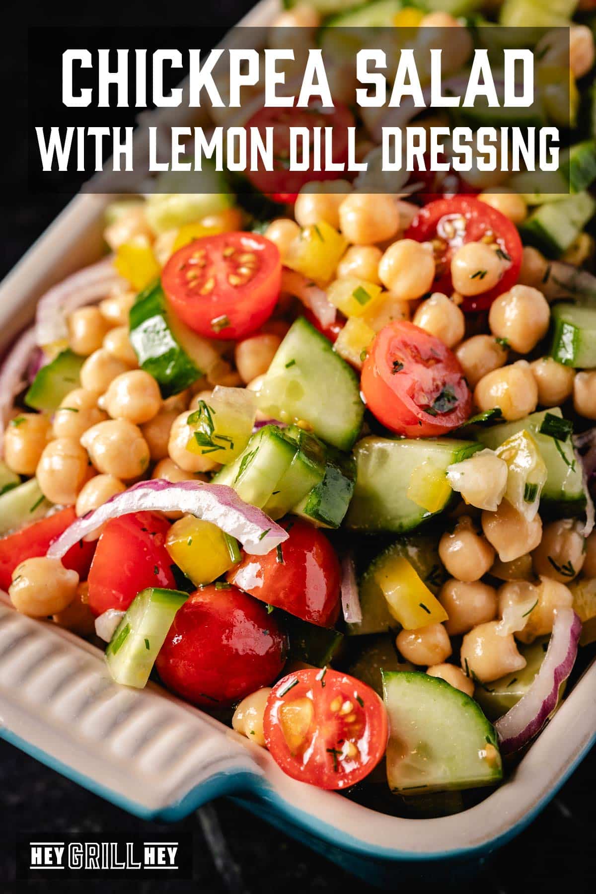 A chickpea, tomato, and cucumber salad in a casserole dish. The text overlay reads "Chickpea Salad with Lemon Dill Dressing" at the top, and "Hey Grill Hey" at the bottom.