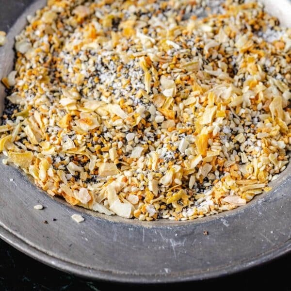 A metal plate covered with a salt, pepper, garlic, and onion, seasoning.