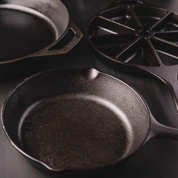 Two skillets next to a range on a stove.