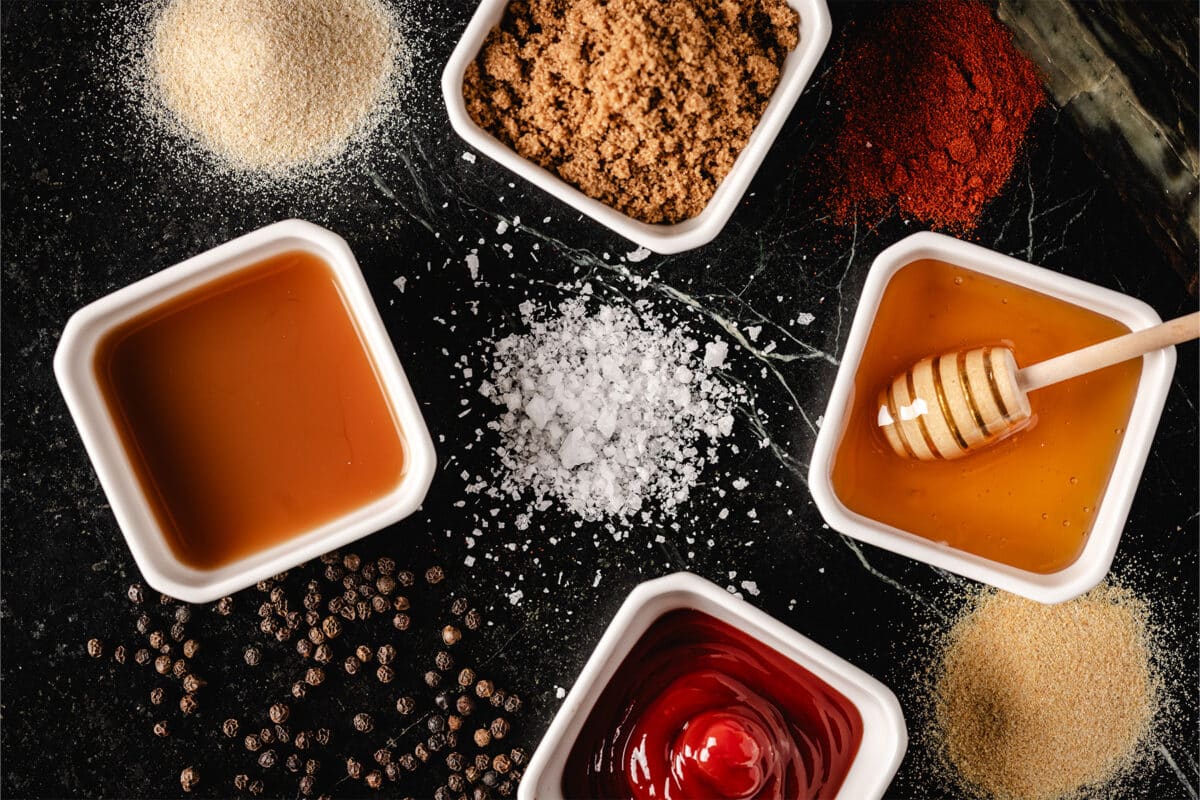 White bowls and small piles of seasoning ingredients.