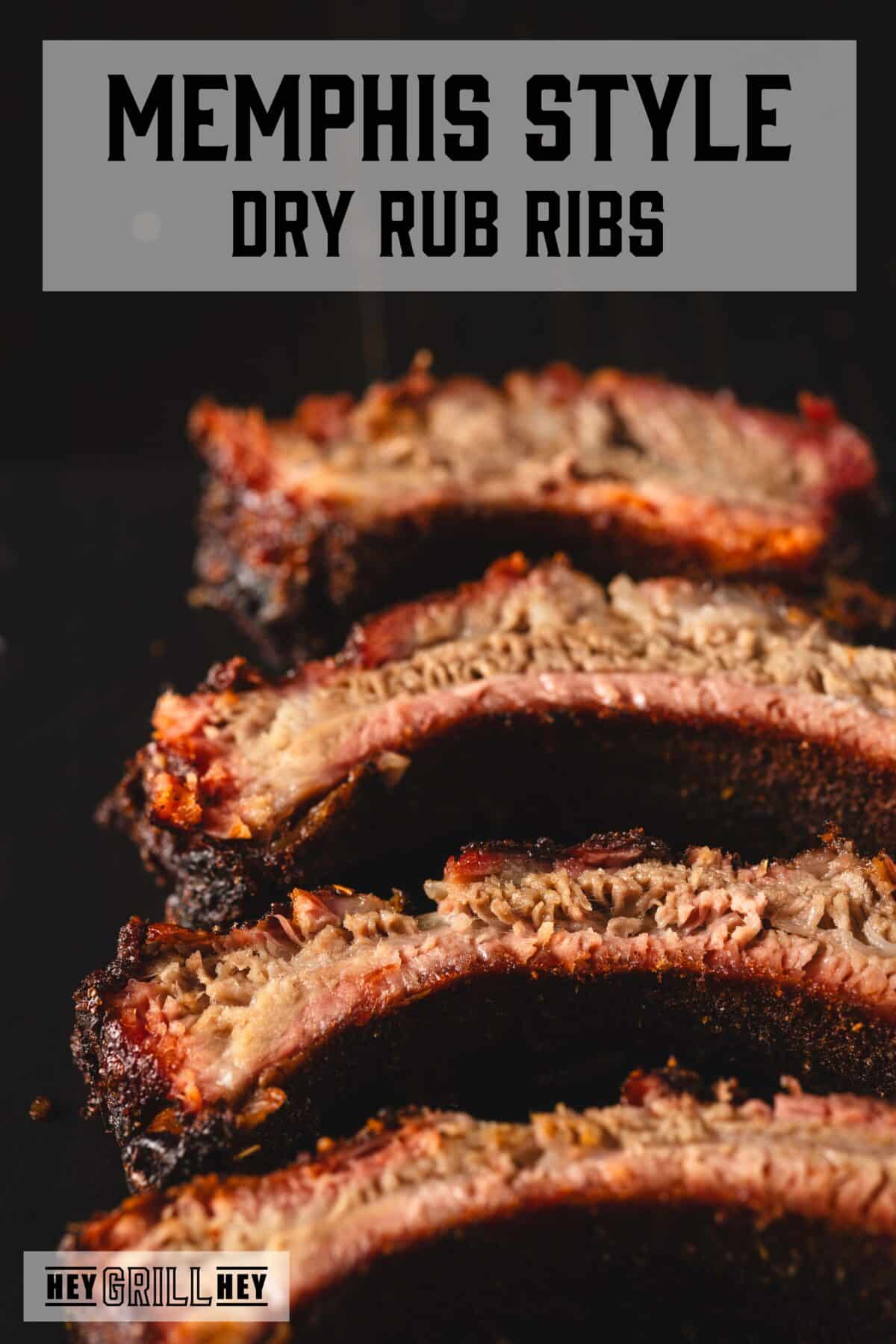 Sliced ribs on a black plate. The text overlay reads "Memphis Style Dry Rub Ribs" at the top, and "Hey Grill Hey" at the bottom.