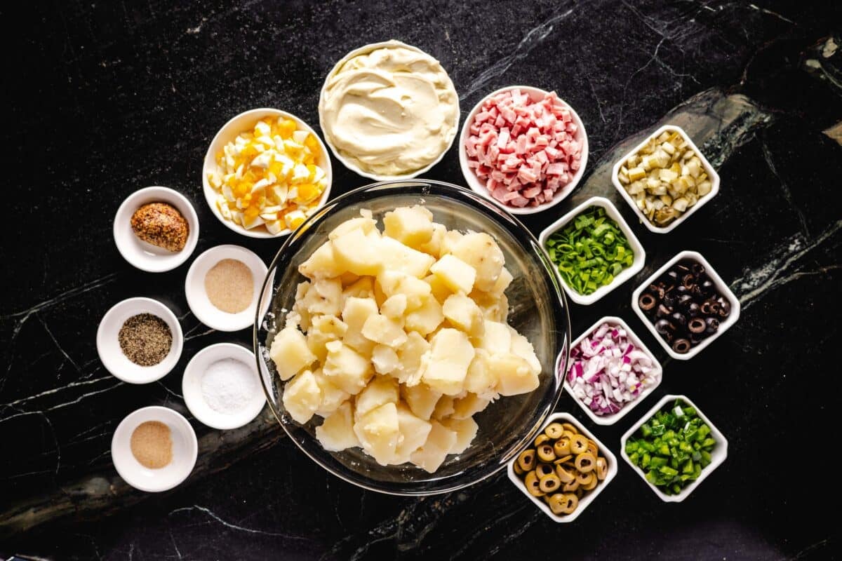 A header of several salads and ingredients for the dressing in individual bowls.