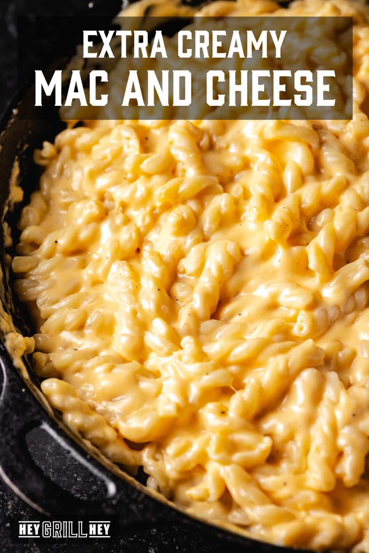 A leading blow and raised of a pan full of Mac and cheese. The overlap of the text reads "Mac and extra creamy cheese" above, e "Hey Grill Hey" in conclusion.