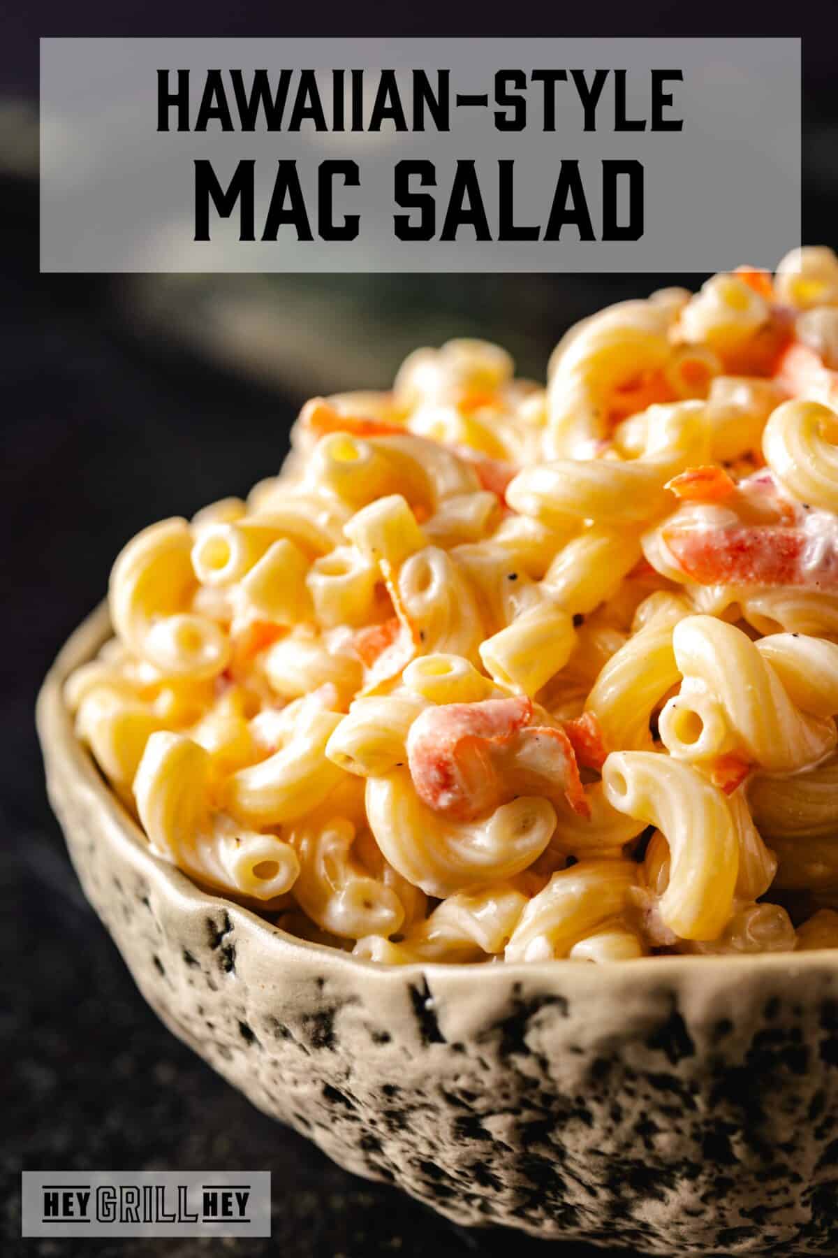 A bowl of macaroni salad. The text overlay reads "Hawaiian-Style Mac Salad" at the top, and "Hey Grill Hey" at the bottom.