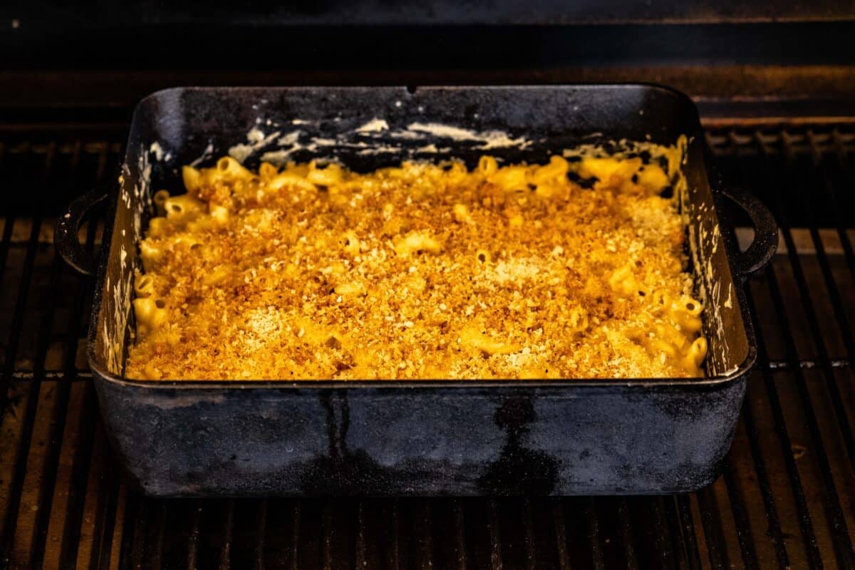 A pasta dish in a cast-iron pan on the grates of a smoker.
