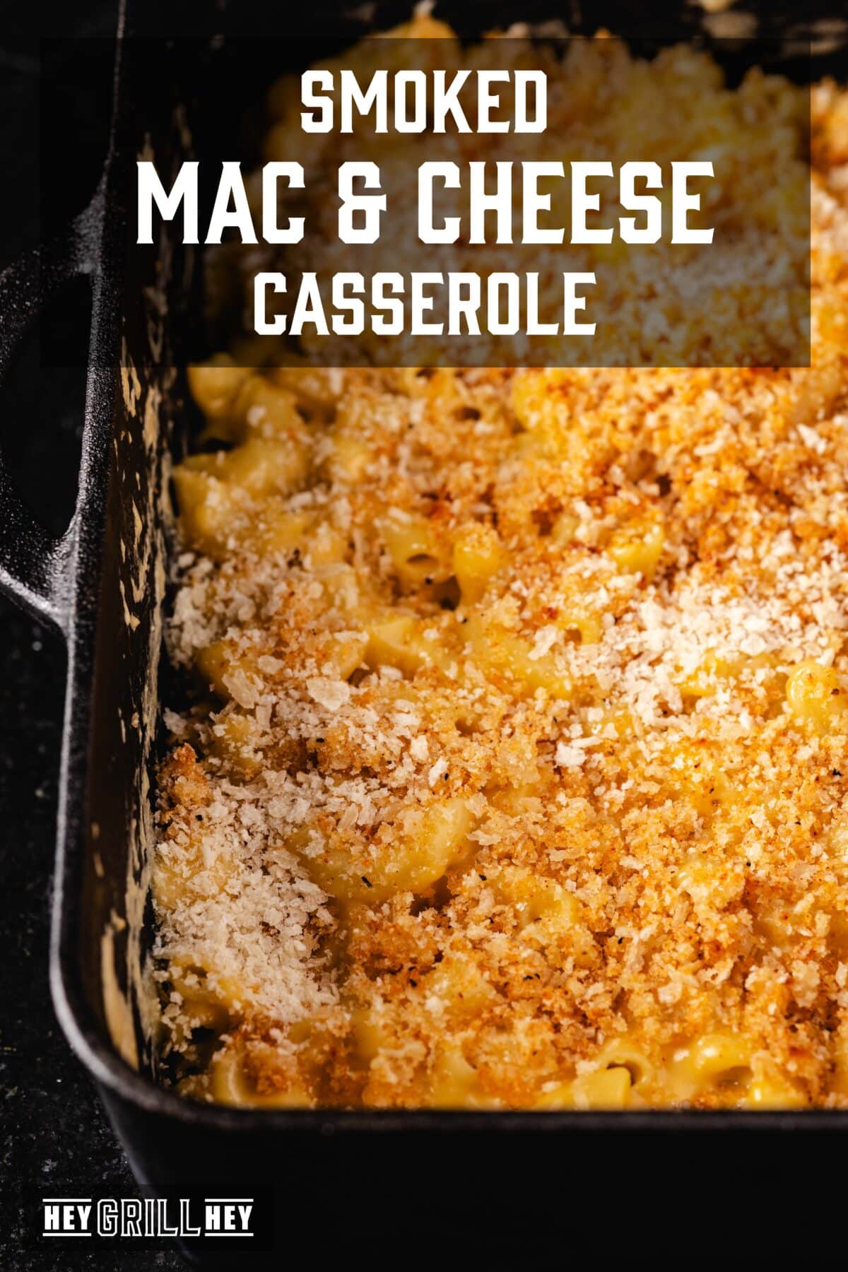 A Dutch oven pan filled with a baked casserole. The text overlay reads "Smoked Mac & Cheese Casserole" at the top, and "Hey Grill Hey" at the bottom.