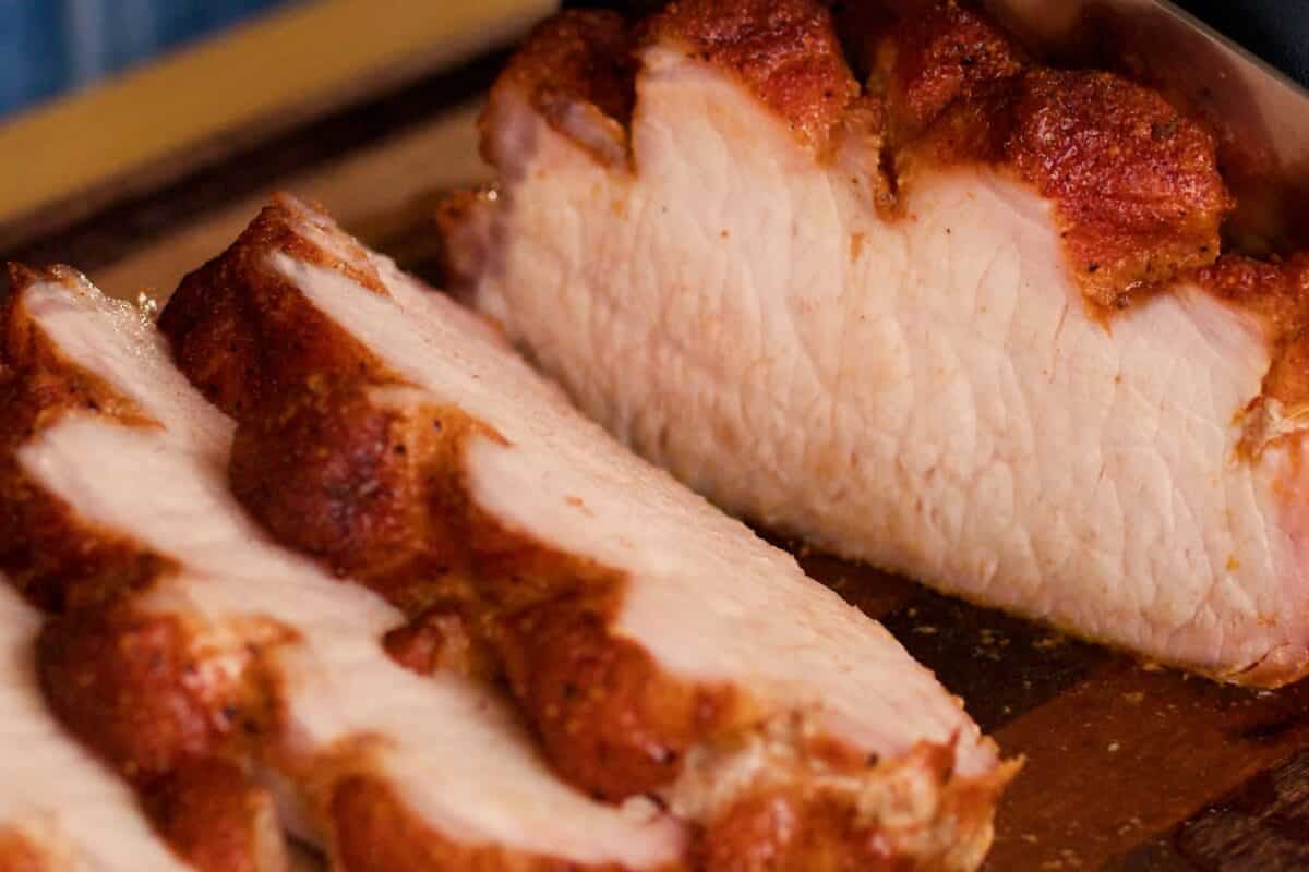 Sliced pork loin shingled on a plate.