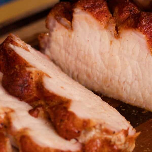Sliced pork loin shingled on a plate.
