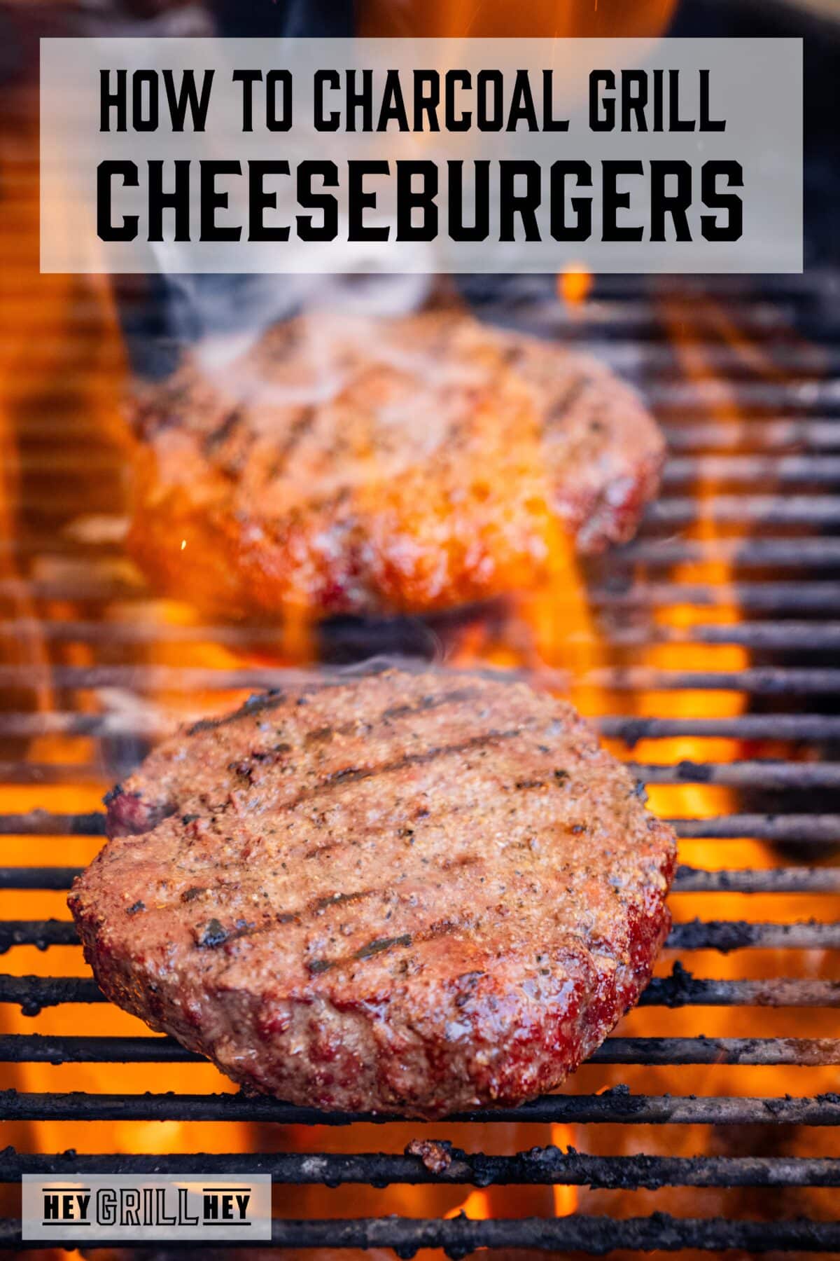 A closeup shot of two burger patties on grill grates. The text overlay reads "How to Charcoal Grill Cheeseburgers" at the top, and "Hey Grill Hey" at the bottom.