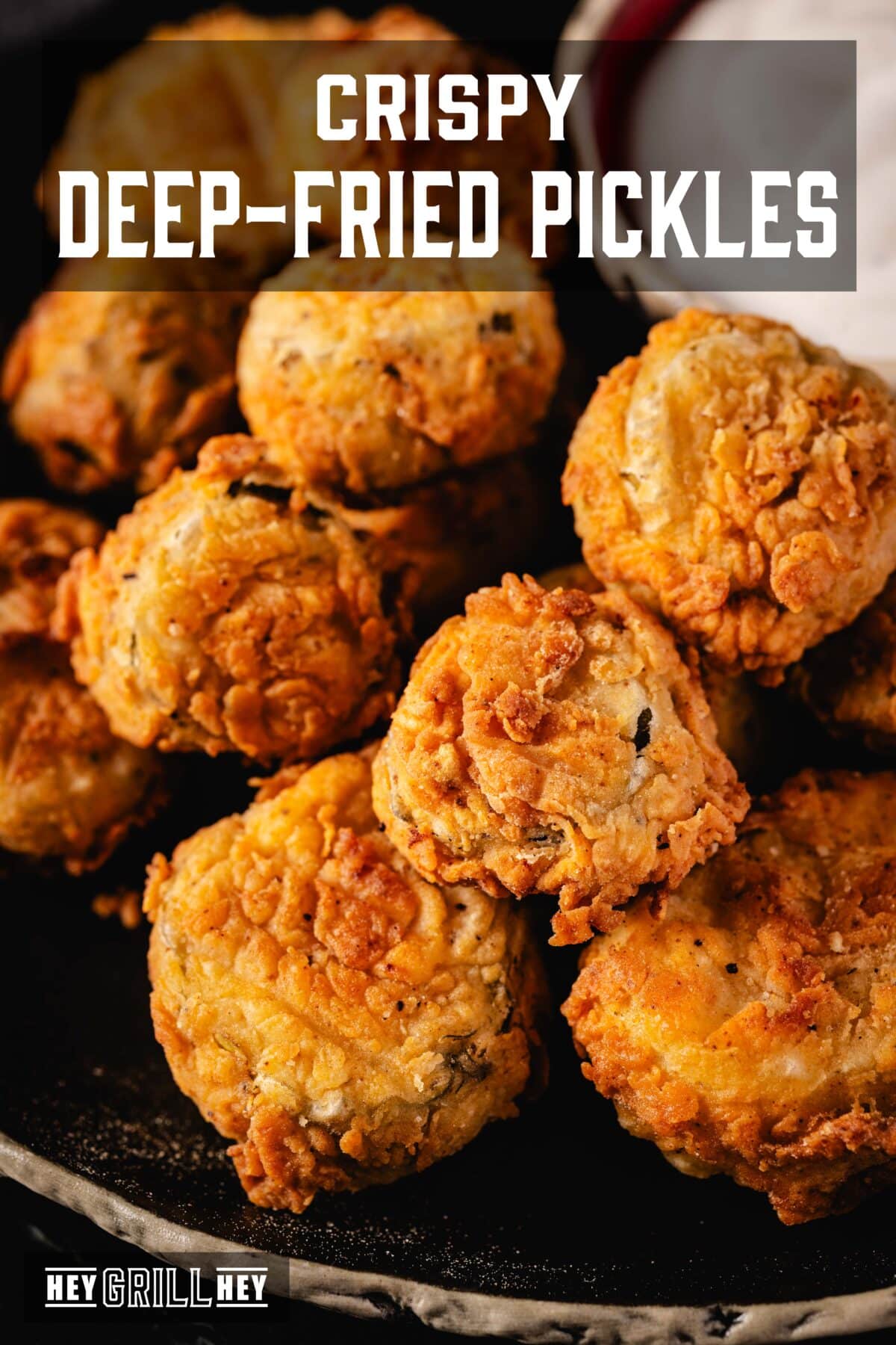 A prominent blow of a pile of fries on a black plate. The overlap of the text reads "Fried crunchy sottacets" above, e "Hey Grill Hey" in conclusion.