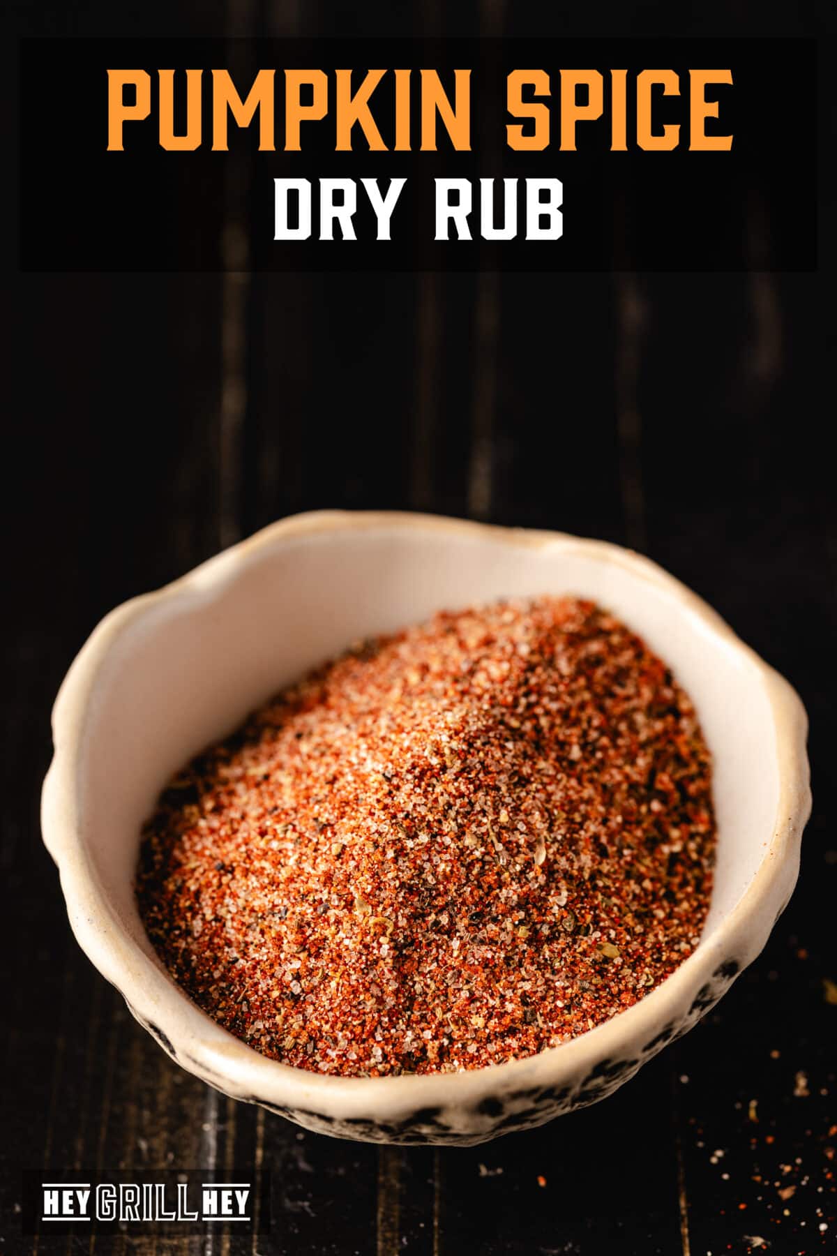 A white bowl filled with a seasoning blend on a dark surface. The text overlay reads "Pumpkin Spice Dry Rub" at the top, and "Hey Grill Hey" at the bottom.