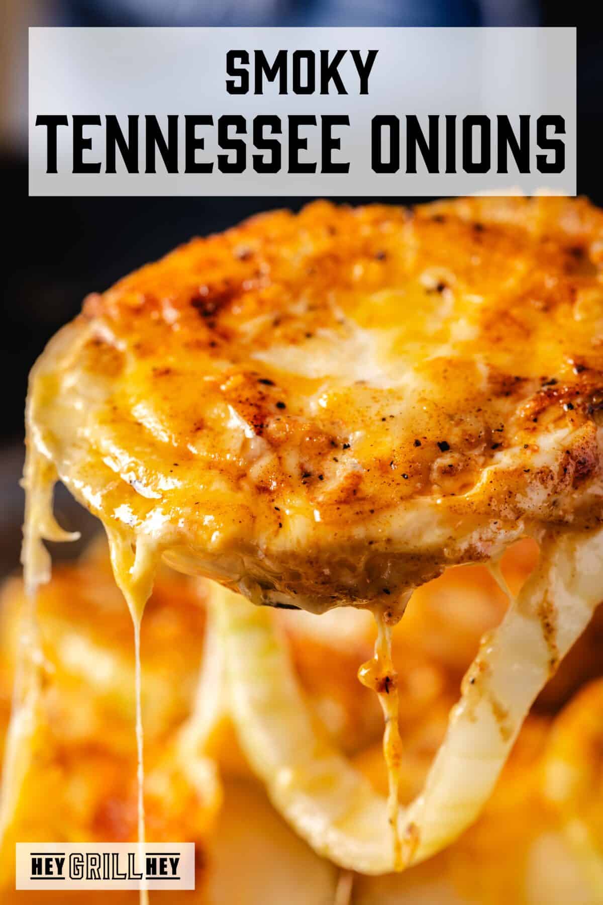 A slice of onion and cheese casserole above a dish. The text overlay reads "Smoky Tennessee Onions" at the top, and "Hey Grill Hey" at the bottom.
