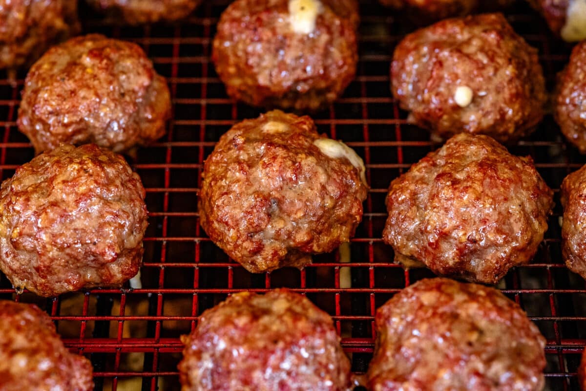 Meatballs on a wire rack in the smoker.