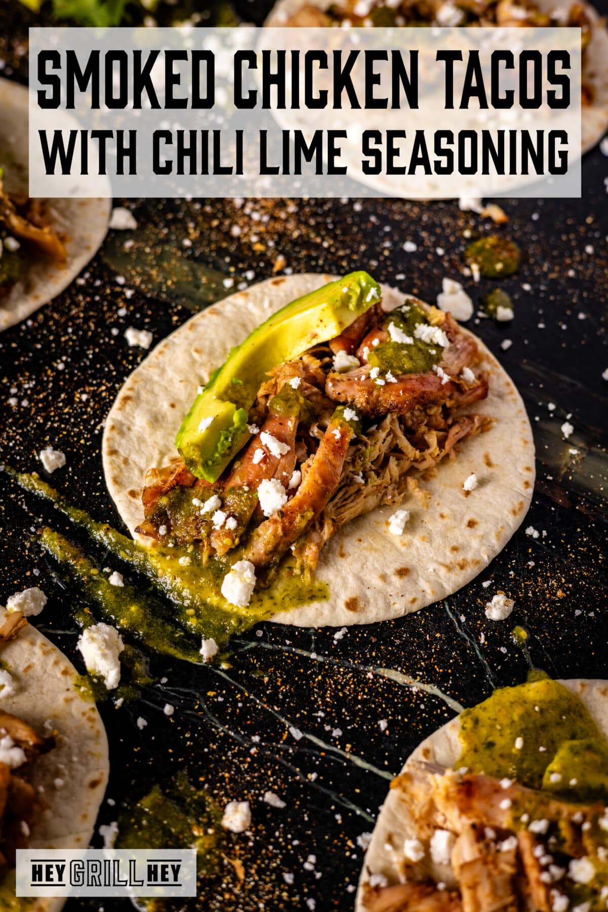 A flour tortilla topped with shredded chicken, avocado slices, and green salsa. The text overlay reads "Smoked Chicken Tacos with Chili Lime Seasoning" at the top, and "Hey Grilled Hey at the bottom.
