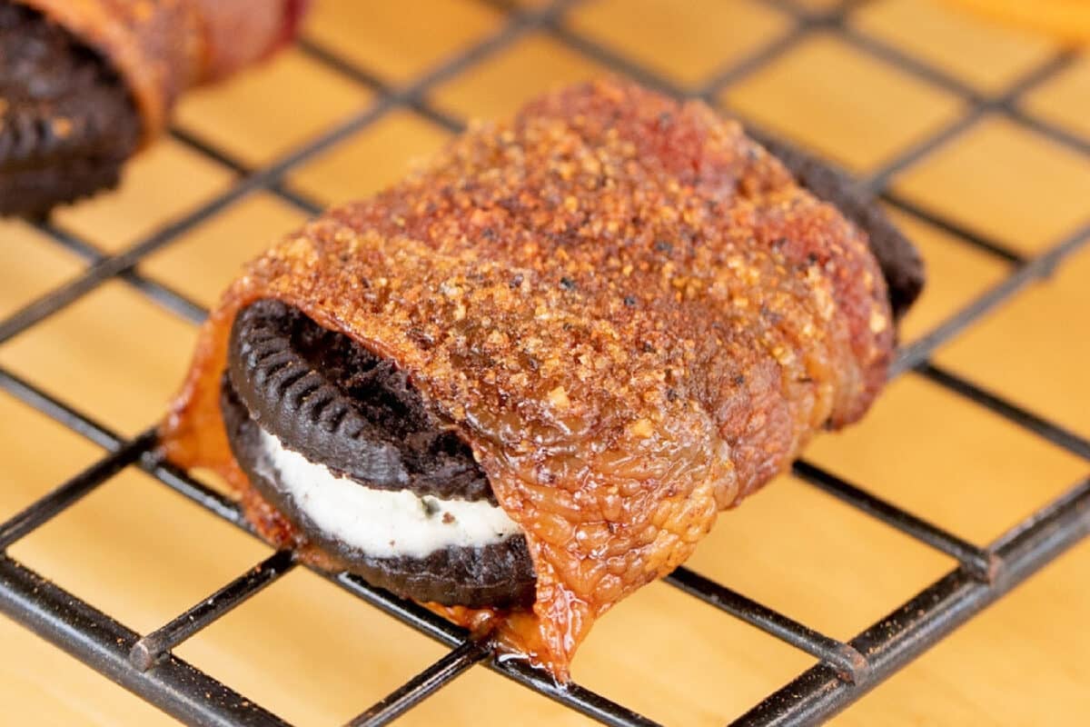 A bacon wrapped Oreo seasoned with Sweet Rub resting on a cooling rack.