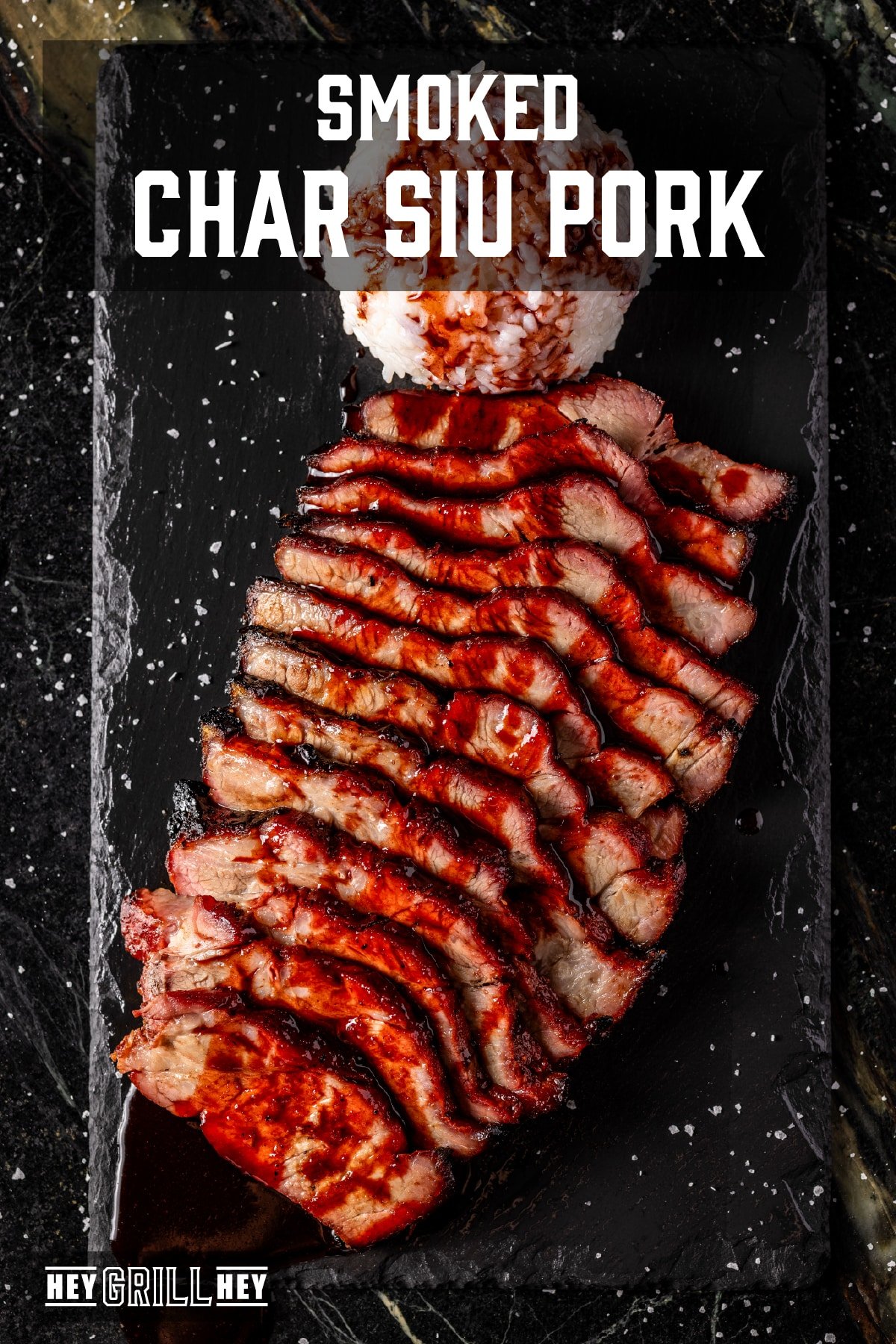 Slices of pork char siu shingled on a black patter and drizzled with BBQ sauce. The text overlay reads "Smoked Char Siu Pork" at the top, and "Hey Grill Hey" at the bottom.