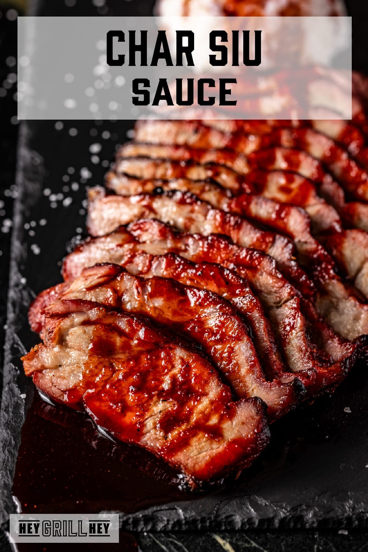 A black platter of sliced and sauced pork. The text overlay reads "Char Siu Sauce" at the top, and "Hey Grill Hey" at the bottom.